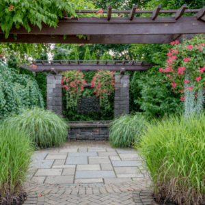 landscape companies in woodstock ga - How to Save Money on Landscaping Projects - a garden with ornamental grasses, vines and flowering baskets hanging from a series of 3 pergolas