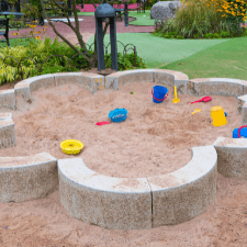 woodstock ga landscaping - How to Create an Outdoor Room for the Family to Enjoy Year-Round - a flower-shaped sandbox with toys in a garden